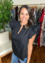 Load image into Gallery viewer, Black cotton poplin blouse with dramatic double ruffle sleeves and split neck with ruffle detailing. Covers some of front and rear but not all.  True to size, wearing size x-small.  For extra length, size up 1 size.
