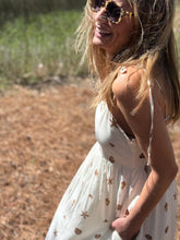 Load image into Gallery viewer, Cerise shell printed Senia midi dress. Empire waistline with gathered skirt with pockets. Contrasting solid printed hemline. Adjustable tie straps and smocking on backside for adjustable fit. Light weight cotton-linen blend and lined.
Sized up for a looser fit, wearing size small.
Good for bump, post bump or no bump!