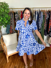 Load image into Gallery viewer, Celeste floral mini dress. Split neck with ruffle detailing. Fly away sleeves, straight skirt with pockets and drop ruffle hemline. Cotton poplin and lined.  True to size, wearing size x-small.
