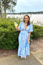 Load image into Gallery viewer, Light blue and white floral printed maxi dress. Puff sleeves, plunge neckline and tiered maxi skirt. Ruched elastic empire double banded waistline. Back zipper closure to neckline, full coverage backside. Cotton poplin.  True to size, wearing size small.   
