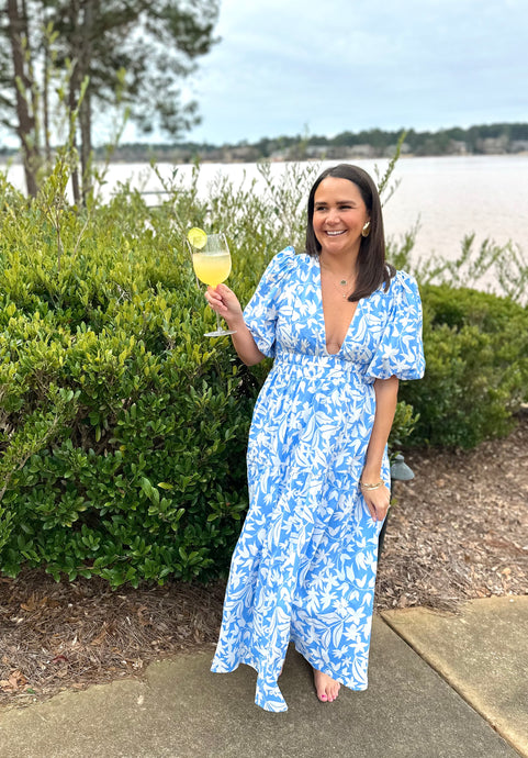 Light blue and white floral printed maxi dress. Puff sleeves, plunge neckline and tiered maxi skirt. Ruched elastic empire double banded waistline. Back zipper closure to neckline, full coverage backside. Cotton poplin.  True to size, wearing size small.   