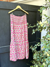 Load image into Gallery viewer, &lt;p&gt;Floral pink printed maxi skirt with smocked elastic banded waistline. Poly silk blend.&lt;/p&gt; &lt;p&gt;True to size, wearing size small.&lt;/p&gt;
