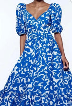 Load image into Gallery viewer, &lt;p&gt;Blue and white geometric printed ankle dress with puff sleeves, cross over bodice and drop flounce hemline. Poly silk blend.&lt;/p&gt; &lt;p&gt;Fits roomy but true to size, wearing size small.&nbsp;&lt;/p&gt; &lt;p&gt;Good for bump, post bump or no bump!&lt;/p&gt;
