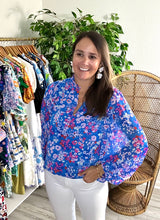 Load image into Gallery viewer, Blue, pink, red and white floral blouse with split neck and balloon long sleeves. Bodice lined and sleeves sheer. Chiffon and cotton blend. Covers most of front and rear.  True to size, wearing size x-small.
