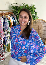 Load image into Gallery viewer, Blue, pink, red and white floral blouse with split neck and balloon long sleeves. Bodice lined and sleeves sheer. Chiffon and cotton blend. Covers most of front and rear.  True to size, wearing size x-small.
