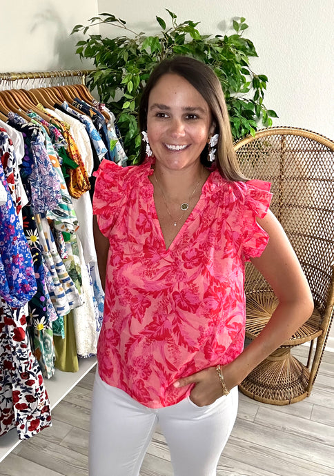 Pink and orange printed cotton blouse with split neck and ruffle flutter sleeves. Pleated ruffles at neckline. Covers some of front and rear. Light weight cotton.  True to size, wearing size small.