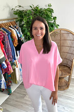 Load image into Gallery viewer, Classic oversized v-neck blouse with dolman sleeves in light pink. Poly silk blend. Covers most of front and rear fully.  Fits roomy, wearing size small.
