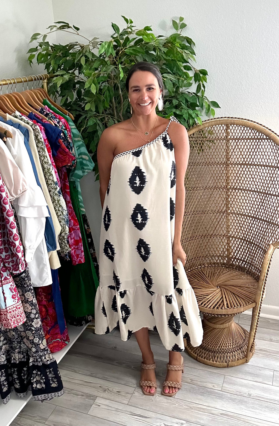 Black and ivory printed midi dress. Rope detailing one shoulder tie with wooden beads. Drop flounce hemline. Linen cotton blend and lined.  True to size, wearing size small.  Size up for bump.