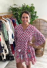 Load image into Gallery viewer, Red, coral and blue mini dress. Multi colored pom pom front tie closure, modest v-neck and flounce mini skirt. Poly silk blend.  Wearing size small, fits more like x-small. Size up if between sizes.
