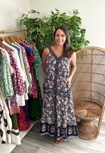 Load image into Gallery viewer, Ink mixed floral printed maxi dress with solid and contrasting pattern bordering. Piping detailing at pockets. Light weight cotton and lined.  True to size, wearing size small.  Good for bump, post bump or no bump!
