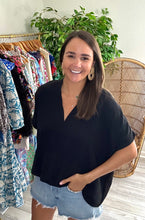 Load image into Gallery viewer, Classic oversized v-neck blouse with dolman sleeves in black. Poly silk blend. Covers most of front and rear fully.  Fits roomy, wearing size small.
