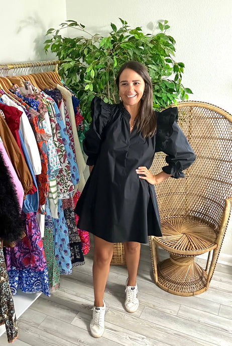 Black poplin mini dress with double ruffle fly away sleeves with long sleeves. Ruffle detailing elastic at wrist for arm placement. Split neck and a-line cut. Cotton poplin.  True to size, fits roomy, wearing size small.  Good for bump, post bump or no bump!