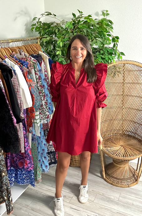 Crimson poplin mini dress with double ruffle fly away sleeves with long sleeves. Ruffle detailing elastic at wrist for arm placement. Split neck and a-line cut. Cotton poplin.  True to size, fits roomy, wearing size small.  Good for bump, post bump or no bump!