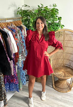 Load image into Gallery viewer, Crimson poplin mini dress with double ruffle fly away sleeves with long sleeves. Ruffle detailing elastic at wrist for arm placement. Split neck and a-line cut. Cotton poplin.  True to size, fits roomy, wearing size small.  Good for bump, post bump or no bump!
