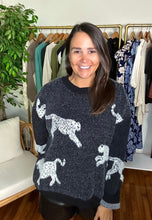 Load image into Gallery viewer, Black sweater with cheetahs. Slight high low hemline. Cotton knit blend.  Fits roomy, true to size, wearing size small.
