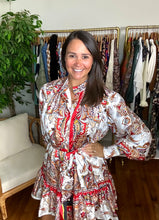 Load image into Gallery viewer, Scarf printed mini dress with mock collar. Functional front buttons, gold pearl with gold trim, straight shift body with drop waist flounce hemline. Removable tie at waist.  True to size, fits roomy, wearing size small.  Good for bump, post bump or no bump!
