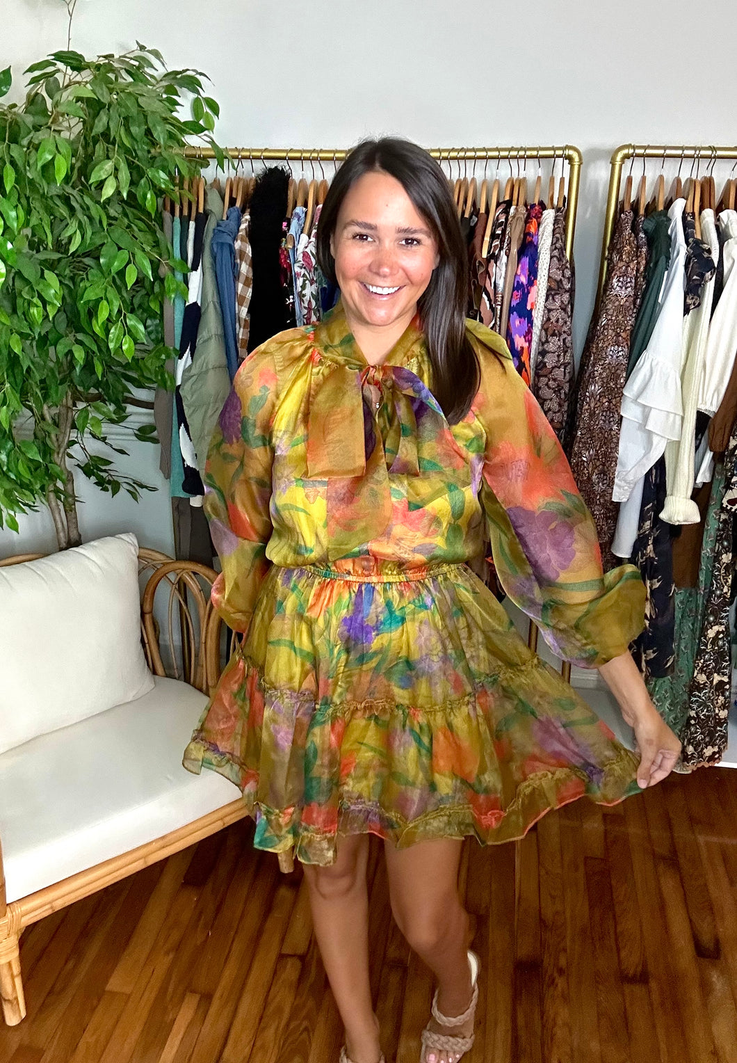 Yellow floral multi mini dress with elastic waistline and cuffs. Tiered skirt overlay and functional front bow at neckline. Lined bodice and sheer sleeves. Silk lining with organza overlay.  True to size, wearing size x-small.