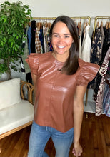 Load image into Gallery viewer, Cognac vegan leather blouse with double ruffle sleeves. Back zipper closure and cross stitching on front.  True to size, wearing size small.
