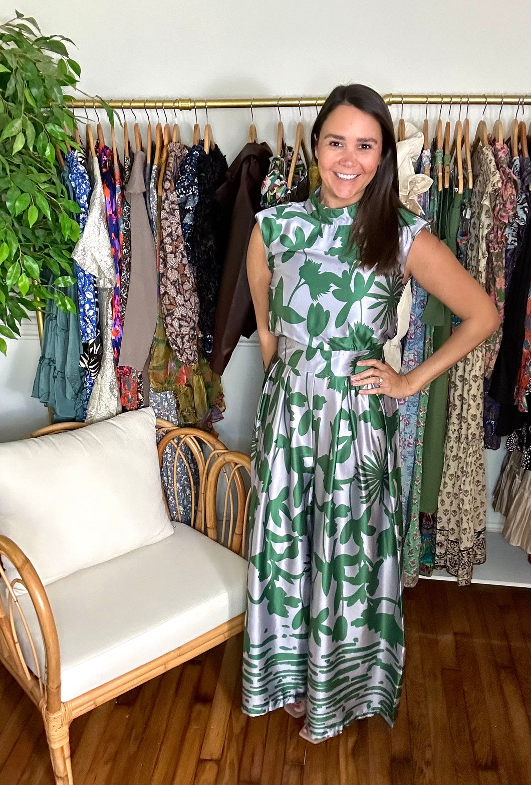 Green and silver tulip and palm printed jumpsuit. Mock collar, shoulder pads and empire waist. Flare pants and structured bodice. Back zipper closure. Poly silk blend.  True to size, wearing size small.
