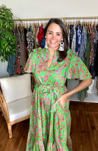 Load image into Gallery viewer, Jade floral Escondido ankle dress. Bright green and pink floral printed dress with fly away sleeves and ruffle ruched detailing at shoulders. Ruffle detailing at neckline, empire waist with removable tie at waist. Tiered skirt with pockets. Light weight cotton poplin.  True to size, wearing size x-small.  Good for bump, post bump or no bump!
