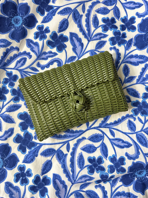 Olive woven clutch with front knot closure. Woven plastic, perfect for spring and summer.
