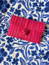 Load image into Gallery viewer, Hot pink woven clutch with front knot closure. Woven plastic, perfect for spring and summer.

