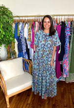 Load image into Gallery viewer, Floral printed maxi dress with drop waistline and tiered skirt. Gathered throughout and pockets on skirt. Crew neckline with back button closure and flutter sleeves. Cotton blend with embroidered detailing.  Fits oversized but true to size, wearing size small.  Good for bump, post bump or no bump!

