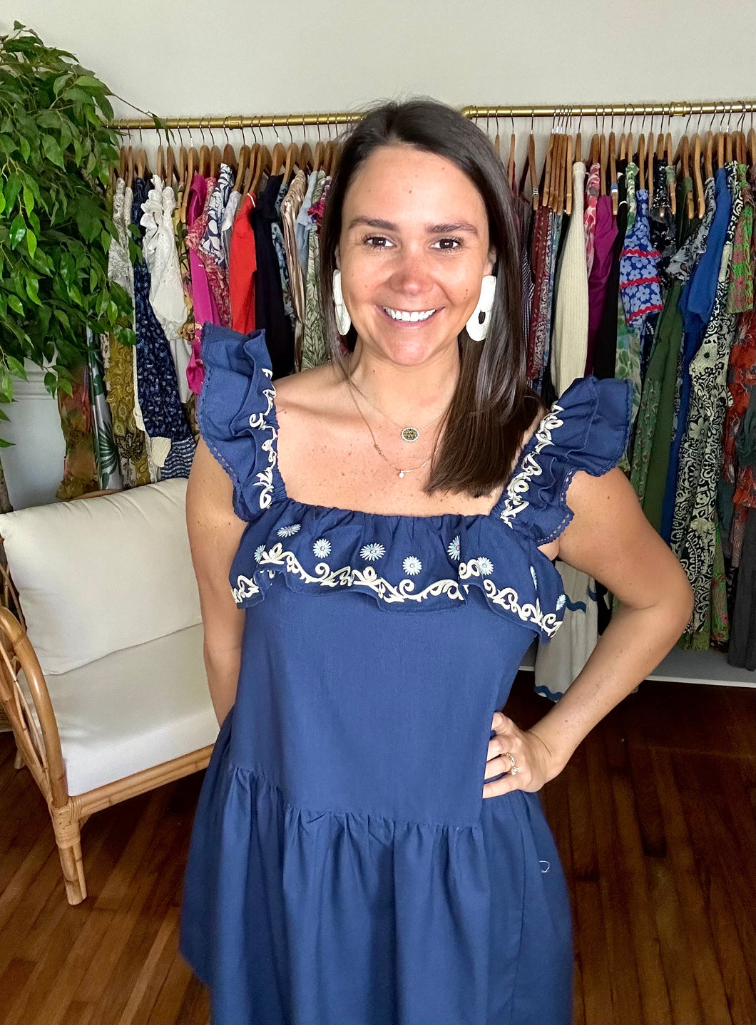 <p>Navy linen mini dress with drop waist flounce skirt. Embroidered ruffle detailing at squared neckline and straps. Double ruffle on sleeve with swiss dot trim. Elastic neckline and straps.</p> <p>True to size, wearing size small.</p> <p>Good for small bump, post bump or no bump!</p>