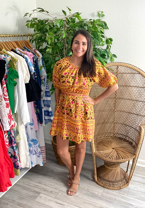 Fiesta mustard printed mini dress. Empire waist, backless back with button closure at neck. Back zipper closure and bow in back. Light weight cotton. Slip suggested.  Size up, wearing size medium.