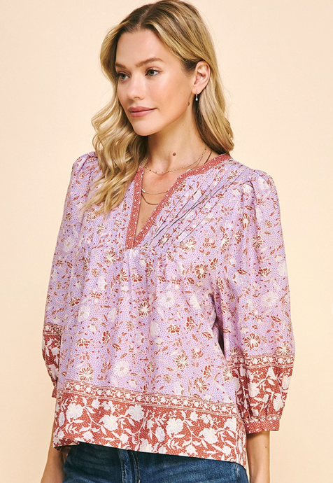 <p>Lavender and rust block printed blouse with pin tuck detailing on yoke. Bordered detailing of contrasting print. Light weight cotton. Covers most of front and backside.</p> <p>True to size, wearing size small.</p>