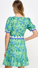 Load image into Gallery viewer, &lt;p&gt;Blue and green printed mini dress with contrasting block printed belt with rattan buckle. Squared neckline, puff sleeves and ruffle hemline. Poly silk blend.&lt;/p&gt; &lt;p&gt;Runs a little small, wearing size medium. If between sizes, size up.&lt;/p&gt; &lt;p&gt;I carry my weight in my stomach, wanted to have a little extra room.&lt;/p&gt;
