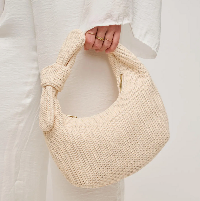 The Penny handbag. Woven in lime with faux tie at handle. Zipper closure Zipper pocket inside. Can be worn on shoulder.

Upgrade your wardrobe with this ivory woven handbag, a perfect mix of timeless elegance and modern style. Featuring a beautifully textured woven design, this bag adds a chic touch to any outfit. The faux tie detail at the handle enhances its sophisticated appeal, while the secure zipper closure keeps your belongings safe. Inside, a zipper pocket offers convenient storage for smaller essen