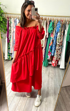 Load image into Gallery viewer, Red off shoulder ankle dress with ruffle detailing and asymmetrical layered front skirt. Poly silk and cotton blend.  True to size, meant to fit roomy, wearing size small.  Good for bump, post bump or no bump!
