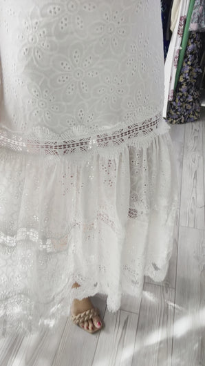White eyelet ankle dress with detailed straps as well as detailed lace tiered layers throughout. Back zipper closure, lined, cotton.  True to size, wearing size small.