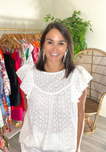 Load image into Gallery viewer, Eyelet blouse with ruffle flutter sleeves and back button keyhole closure. Wearing nude bra and no tank. Covers rear. Light weight cotton.  Fits roomy, wearing size small.
