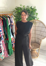 Load image into Gallery viewer, Jumpsuit with shoulder pads, elastic waist and pockets. Back keyhole closure. Silk crepe blend.  True to size, wearing size small.
