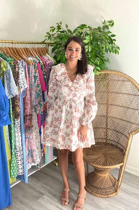 Eyelet floral mini dress with ruffle v-neck front and back. Double lined with ruffle cuff sleeves and back tie closure. Back zipper closure.  True to size, wearing size small.
