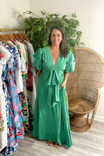 Load image into Gallery viewer, Kelly green maxi dress with pockets, exaggerated puff sleeves, elastic waist with adjustable drawstring tie at waist. Polyester silk blend.  Fits roomy, wearing size small.  Good for bump, post bump or no bump!
