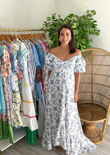 Load image into Gallery viewer, Off shoulder blue and white maxi dress. High low hemline, modest v-neck and double gathered puff sleeves. Back zipper closure. Silk blend.  If between sizes or bustier, size up. Wearing size small.
