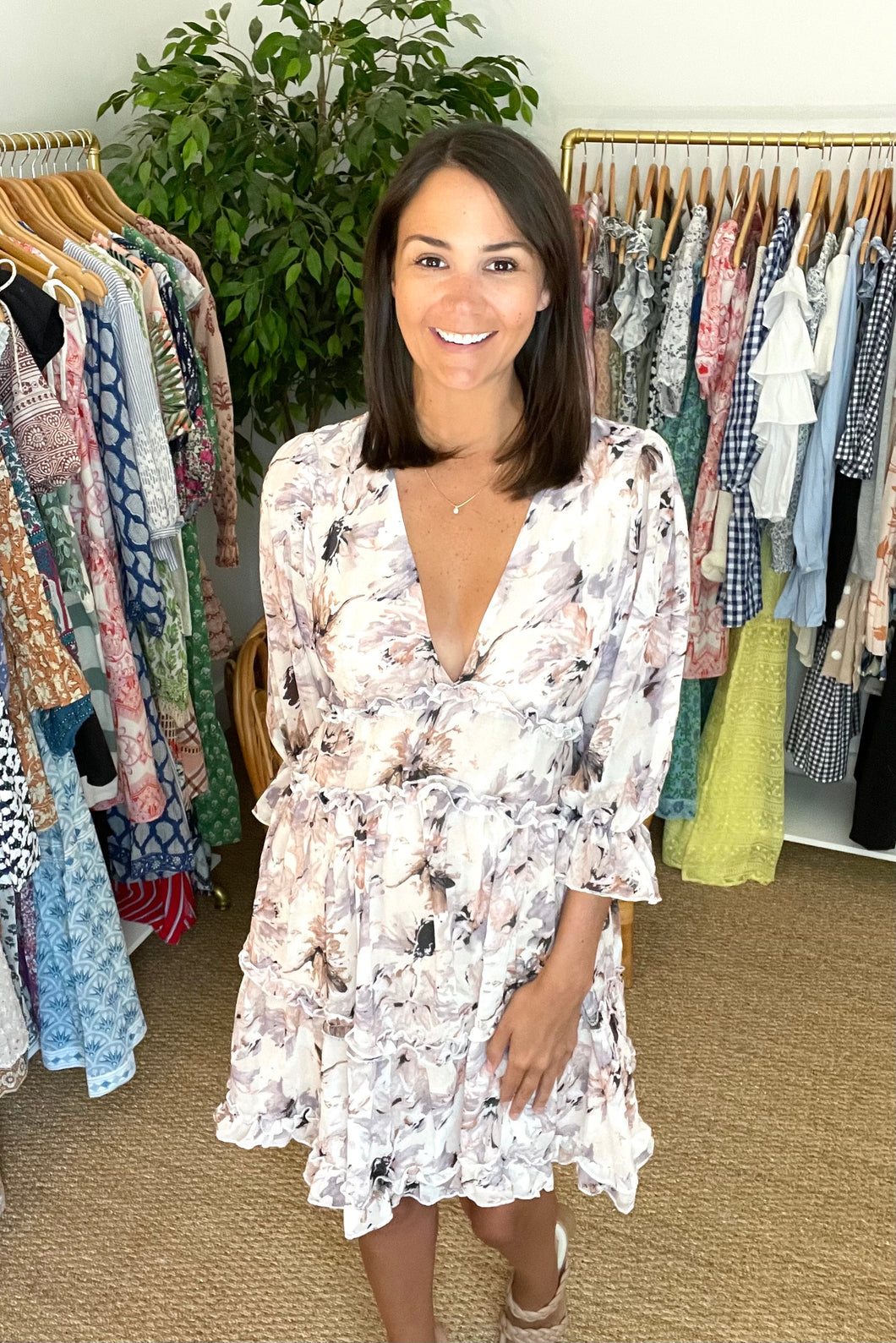 Floral lavender ruffle dress with deep v-neck and ruffle detailing. Zipper closure in back.  True to size, wearing size small.