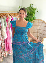 Load image into Gallery viewer, Marilyn ankle dress with double flutter sleeves, smocked bodice and pockets. Tiered double lined skirt. Organic cotton.  True to size, wearing size x-small.
