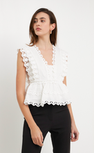 Load image into Gallery viewer, Peplum blouse with abstract lace detailed trim. Double layered peplum and sleeves. Back zipper closure. Cotton blend.  True to size, wearing size small. Could wear x-small but sized up for length.

