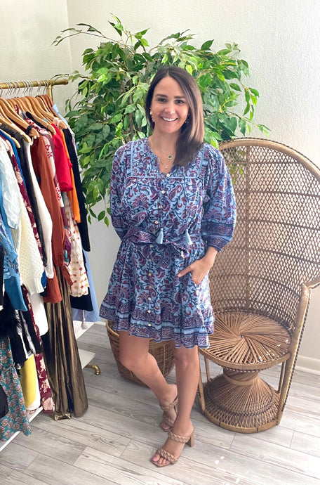 Cade mini dress in delhi block print. Light weight cotton with slip included. Front functional buttons, front tie tassel closure and drop ruffle hemline. Removable tie at waist.  True to size, wearing size x-small.
