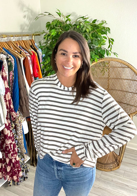 Dark gray and white striped t-shirt. Long sleeves with vertical cuffs. Conservative cropped. Extremely soft light weight cottons.  True to size, wearing size small.  Size up for extra length.