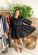 Load image into Gallery viewer, Puff sleeve textured organza mini dress. Black floral with ruffle drop waist. Back keyhole closure and lined. 5&#39;5 for reference.  True to size, wearing size small.  Good for bump, post bump or no bump!
